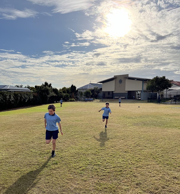 Students running on the school field.